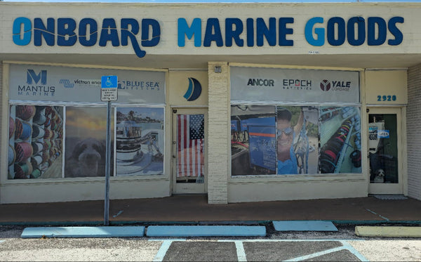 Storefront of Onboard Marine Goods with large windows displaying various items.